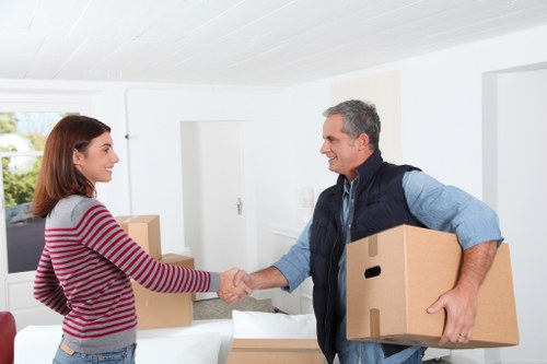 Professional movers carrying furniture during a Longlands relocation